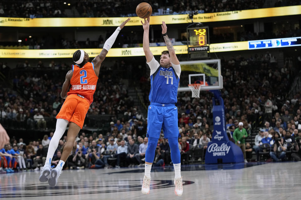 Dallas Mavericks guard Luka Doncic (77) shoots against Oklahoma City Thunder guard Shai Gilgeous-Alexander (2) during the first half of an NBA basketball game in Dallas, Saturday, Dec. 2, 2023. (AP Photo/LM Otero)