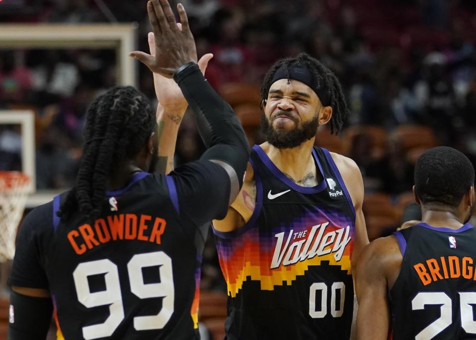 Phoenix Suns center JaVale McGee (00) and forward Jae Crowder (99) congratulate each other as they pull ahead off the Miami Heat during the second half of an NBA basketball game, Wednesday, March 9, 2022, in Miami. (AP Photo/Marta Lavandier)
