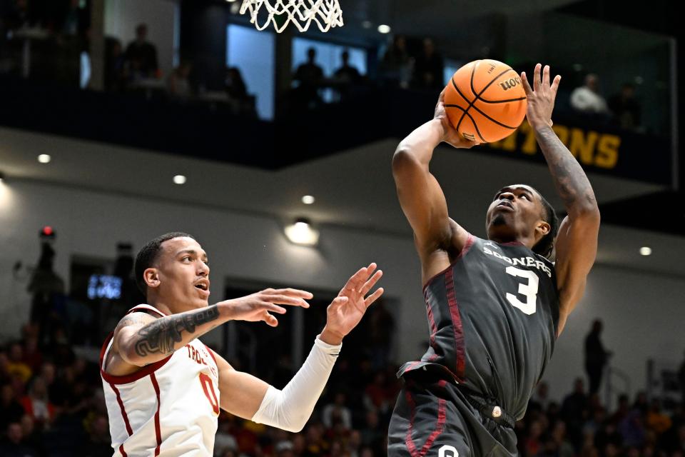 Oklahoma guard Otega Oweh (3) shoots over Southern California guard Kobe Johnson (0) during the second half of an NCAA college basketball game Friday, Nov. 24, 2023, in San Diego. (AP Photo/Denis Poroy)