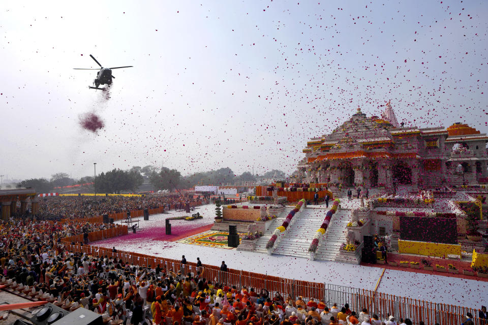 An Indian Air Force helicopter showers flower petals during the opening of a temple dedicated to Hinduism's Lord Ram in Ayodhya, India, Monday, Jan. 22, 2024. Indian Prime Minister Narendra Modi opened the controversial Hindu temple built on the ruins of a historic mosque in the holy city of Ayodhya in a grand event that is expected to galvanize Hindu voters in upcoming elections. (AP Photo/Rajesh Kumar Singh)