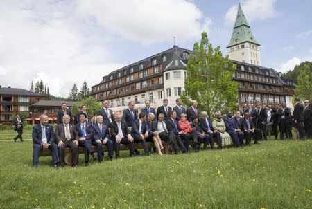 German Chancellor Angela Merkel and other G7 summit participants gather outside the Elmau castle in Kruen near Garmisch-Partenkirchen, Germany, June 8, 2015. REUTERS/Michael Kappeler/Pool