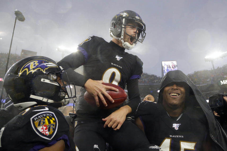 Baltimore Ravens kicker Justin Tucker (9) offered a helping hand before the third day of the draft. (AP Photo/Julio Cortez, File)