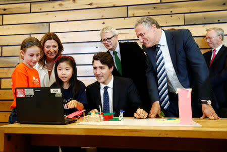 Canada's Prime Minister Justin Trudeau and Sidewalk Labs CEO Dan Doctoroff (R) look at city models built by children before a press conference where Alphabet Inc, the owner of Google, announced the project "Sidewalk Toronto", that will develop an area of Toronto's waterfront using new technologies to develop high-tech urban areas in Toronto, Ontario, Canada October 17, 2017. REUTERS/Mark Blinch