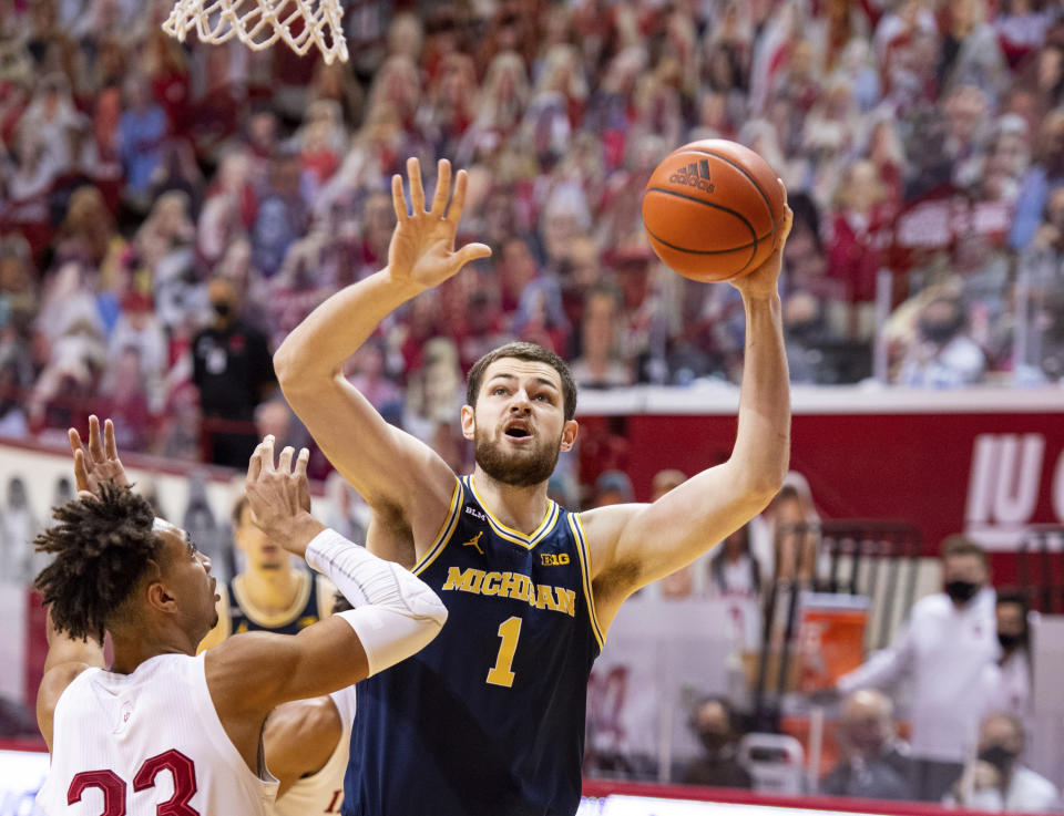 Michigan center Hunter Dickinson (1) shoots over the defense of Indiana forward Trayce Jackson-Davis (23) during the first half of an NCAA college basketball game, Saturday, Feb. 27, 2021, in Bloomington, Ind. (AP Photo/Doug McSchooler)