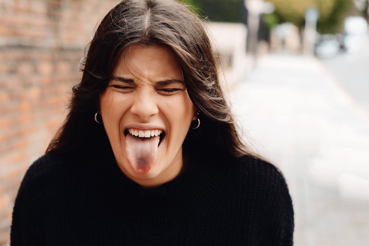 young woman sticking out tongue