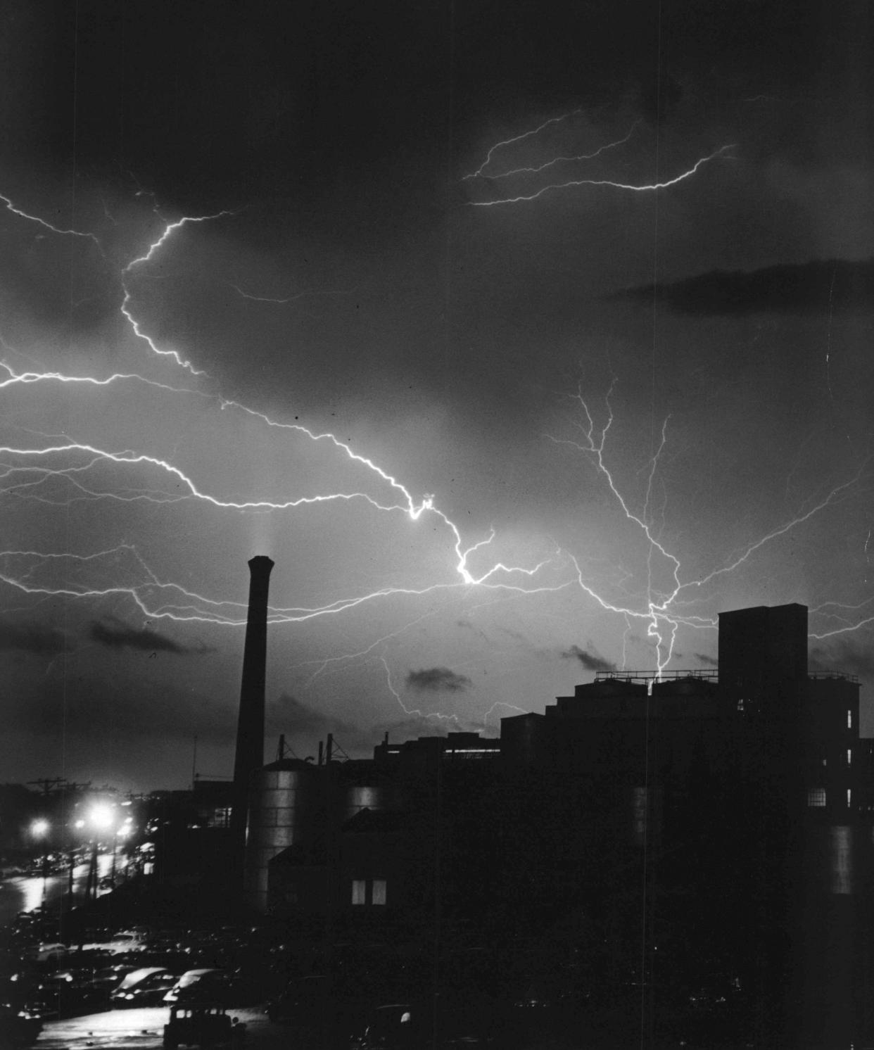 A 1952 Press Photo captured lightning flashing across the sky accompanied by loud thunderclaps and a half-inch of rain. There were power failures because of downed wires and transformers hit by lightning. The picture was taken with the camera pointed south from the Milwaukee Road bridge spanning W. Capitol Drive near N. 32nd Street. A.O. Smith Corporation is outlined against the lightning flashes.