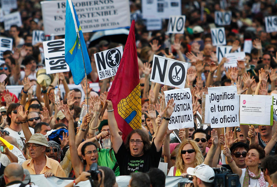 Protesters carry banners against financial cuts and unemployment as they demonstrate against the country's near 25 percent unemployment rate and stinging austerity measures introduced by the government, in Madrid, Spain, Saturday, July 21, 2012. (AP Photo/Andres Kudacki)
