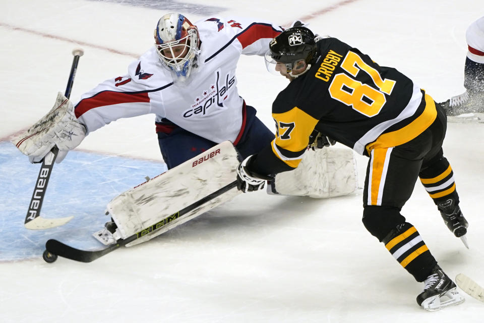 Pittsburgh Penguins' Sidney Crosby (87) gets a shot past Washington Capitals goaltender Vitek Vanecek (41) for an overtime goal in an NHL hockey game in Pittsburgh, Tuesday, Jan. 19, 2021. The Penguins won 5-4. (AP Photo/Gene J. Puskar)