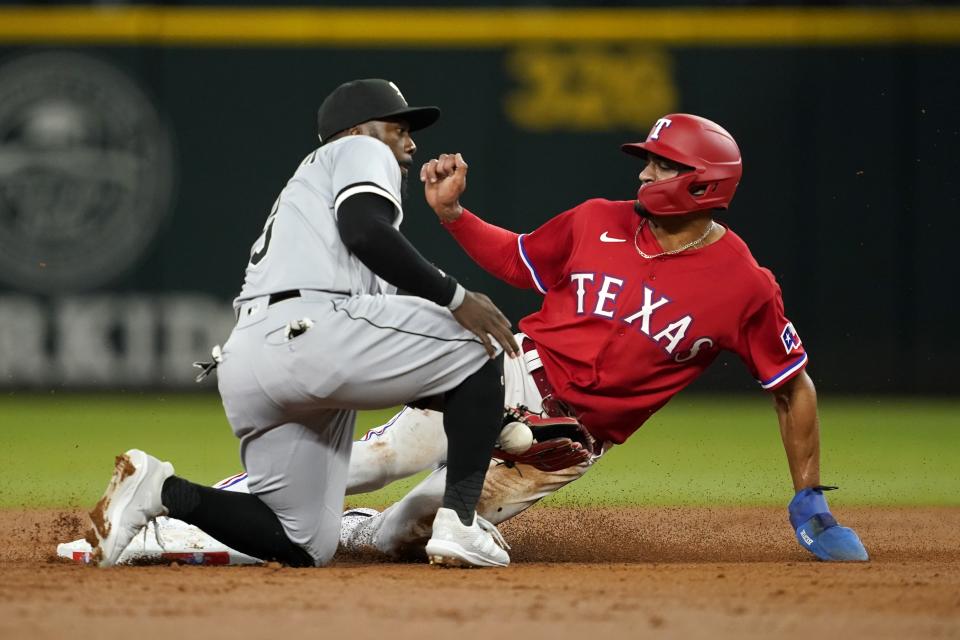 Chicago White Sox' Josh Harrison tries to catch the throw as Texas Rangers' Bubba Thompson steals second during the second inning of a baseball game, Friday, Aug. 5, 2022, in Arlington, Texas. (AP Photo/Tony Gutierrez)