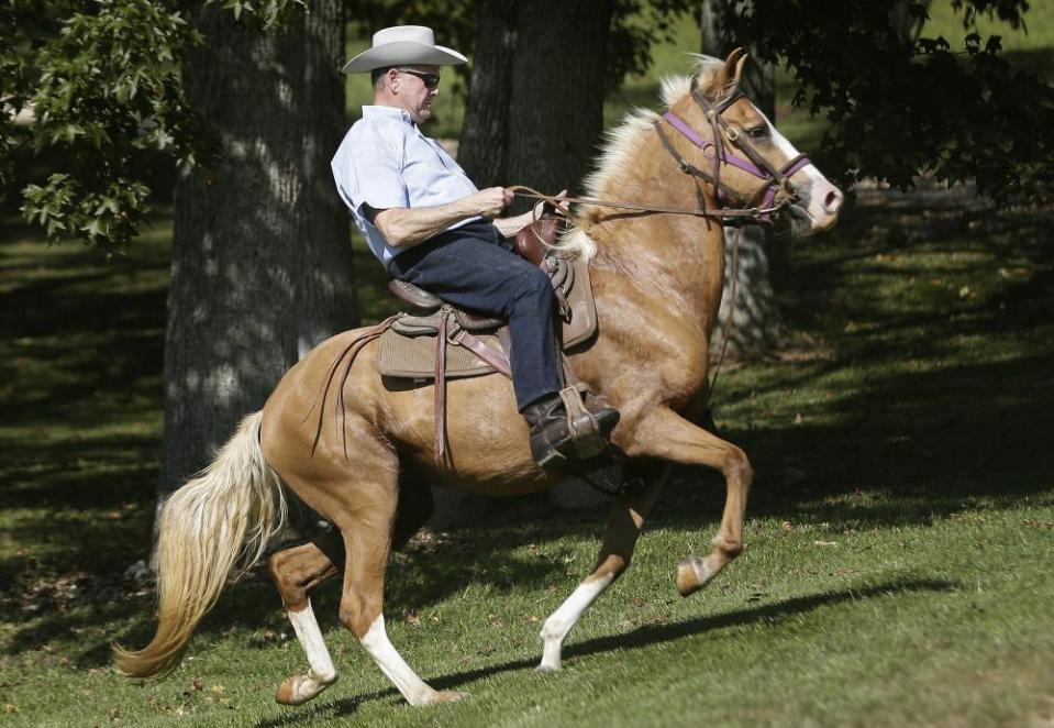 Former Alabama chief justice Roy Moore rides in on a horse to vote in Gallant, Alabama.