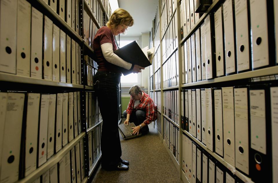 Employees of the ITS (International Tracing Service) research documents at the Holocaust Archive on April 28, 2006 in Bad Arolsen, Germany.  (Photo by Ralph Orlowski/Getty Images)