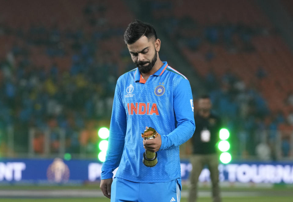 India's Virat Kohli looks at his player of the tournament award after receiving it from BCCI president Roger Benny after the ICC Men's Cricket World Cup final match against Australia in Ahmedabad, India, Sunday, Nov.19, 2023. (AP Photo/Aijaz Rahi)