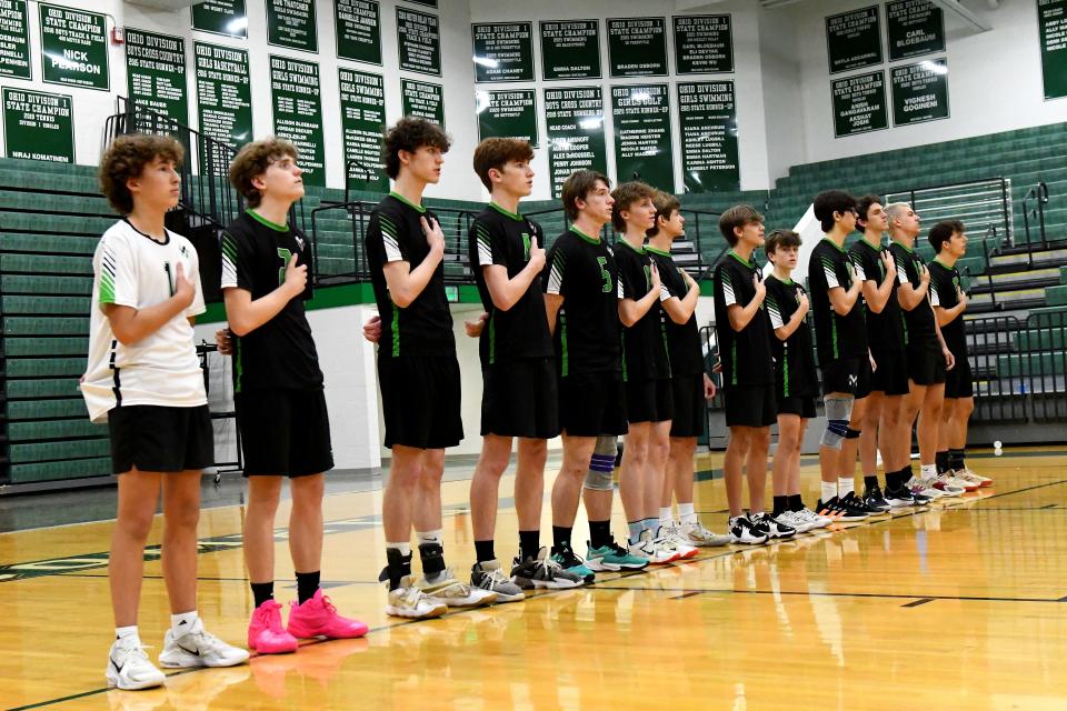 The McNicholas Rockets boys volleyball team honors America during the playing of the National Anthem at the OHSAA Division II boys regional volleyball championship, May 20, 2023.