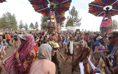 Festival goers dance at the Oregon Eclipse Festival - Credit: AFP