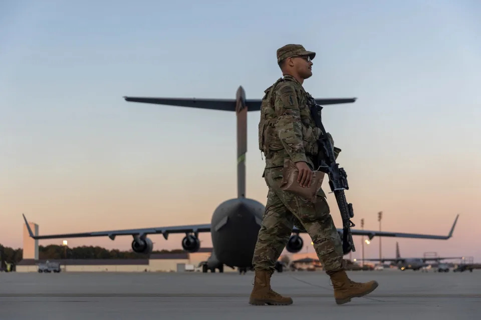 Members of the 82nd Airborne Division of the U.S. Army walk on the tarmac at Pope Field ahead of deployment to Poland from Fort Bragg, North Carolina, in February 2022.