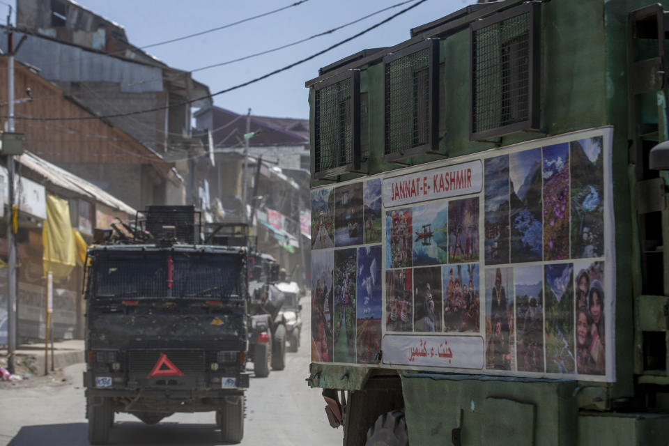 Indian army vehicles leave after the site of a gunbattle between Indian soldiers and suspected militants in Shopian, south of Srinagar, Indian controlled Kashmir, Friday, April 9, 2021. Seven suspected militants were killed and four soldiers wounded in two separate gunfights in Indian-controlled Kashmir, officials said Friday, triggering anti-India protests and clashes in the disputed region. (AP Photo/ Dar Yasin)