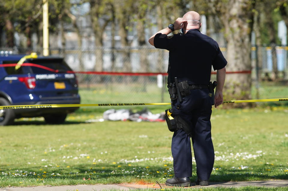 Law enforcement personnel work at the scene following a police involved shooting of a man at Lents Park, Friday, April 16, 2021, in Portland, Ore. Police fatally shot a man in the city park Friday morning after responding to reports of a person with a gun, authorities said. (Beth Nakamura/The Oregonian/The Oregonian via AP)