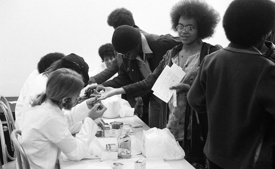 The Black Panthers put on a Black Community Survival Conference at the Civic Auditorium in Oakland, Calif. on March 29, 1972. Participants could take sickle cell anemia tests, register to vote, and receive bags of groceries.<span class="copyright">Dave Randolph—The San Francisco Chronicle/Getty Images</span>
