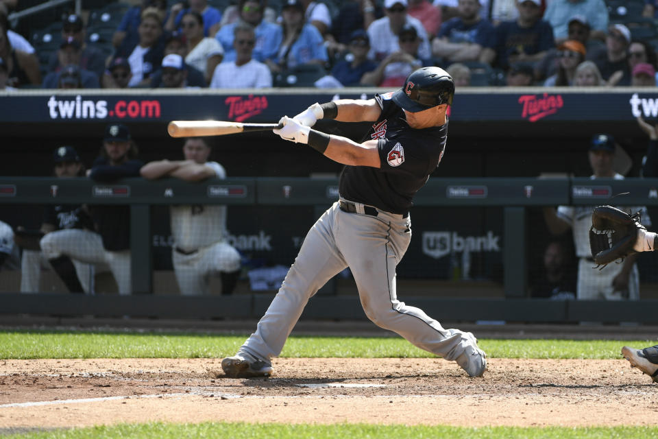 Cleveland Guardians' Kole Calhoun hits a three-run home run against the Minnesota Twins during the tenth inning of a baseball game Wednesday, Aug. 30, 2023, in Minneapolis. Bo Naylor and Jose Ramirez also scored as the Guardians won 5-2. (AP Photo/Craig Lassig)