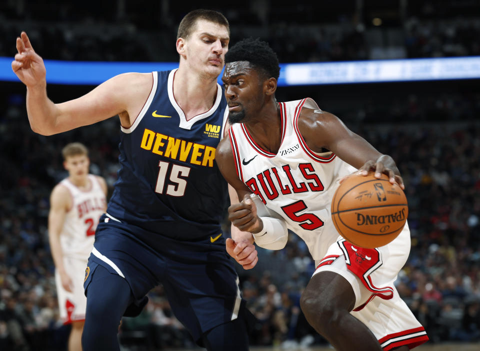 Chicago Bulls forward Bobby Portis (5) drives to the rim past Denver Nuggets center Nikola Jokic (15) in the second half of an NBA basketball game, Thursday, Jan. 17, 2019, in Denver. The Nuggets won 135-105. (AP Photo/David Zalubowski)