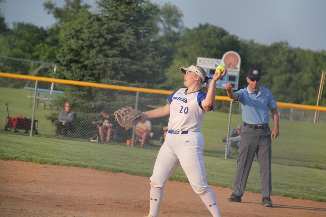 Perry's Emmalee Bell gets an out at first during a game against West Marshall on Monday, June 12, 2023.