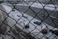 Abandoned vehicles are seen in an motorway way after a snowstorm, in Athens, on Tuesday, Jan. 25, 2022. Army and fire service teams were deployed late Monday to extract hundreds of motorists trapped for hours in snowed-in cars. A snowstorm of rare severity disrupted road and air traffic Monday in the Greek capital of Athens and neighboring Turkey's largest city of Istanbul, while most of Greece, including — unusually — several Aegean islands, and much of Turkey were blanketed by snow. (AP Photo/Michael Varaklas)