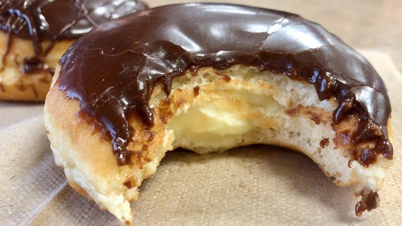 Boston cream filled doughnut with bite taken out