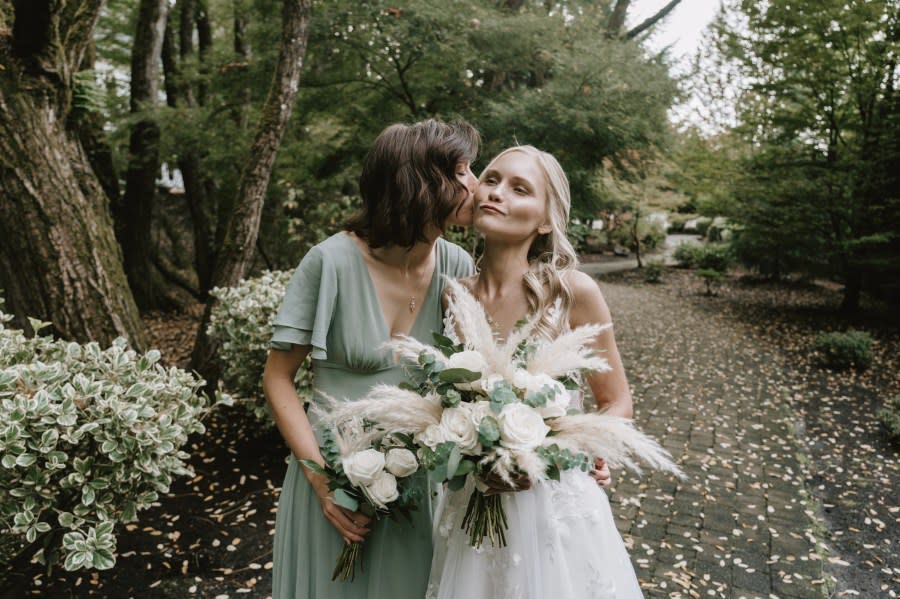 Maid of honor kisses bride