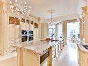 The kitchen features upscale ammenities and marble countertops. (Zoocasa)