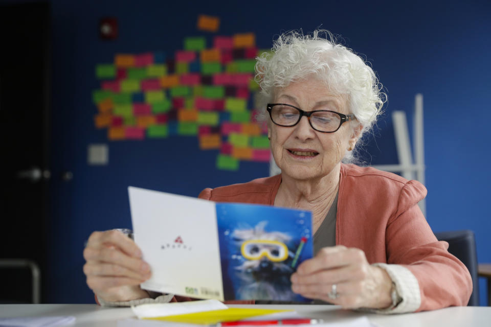 Anne Montgomery, mother of Democratic presidential candidate South Bend Mayor Pete Buttigieg, reads over letters and card written to the campaign in his campaign office in South Bend, Ind., Wednesday, Sept. 25, 2019. (AP Photo/Michael Conroy)