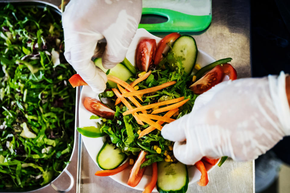 hands preparing a bowl of food