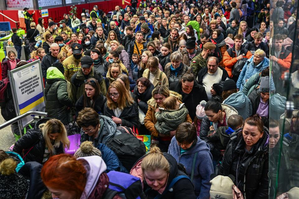 People who fled the war in Ukraine walk toward a humanitarian train to relocate refugees to Berlin on March 15 in Krakow, Poland.