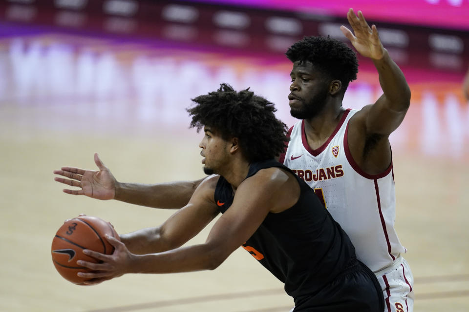 Southern California forward Chevez Goodwin, right, defends against Oregon State guard Ethan Thompson during the first half of an NCAA college basketball game Thursday, Jan. 28, 2021, in Los Angeles. (AP Photo/Ashley Landis)