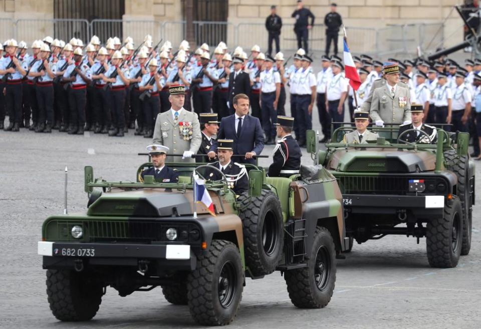 French President Emmanuel Macron (R) arrives with chief of the defence staff, General Francois Lecointre, prior to the annual Bastille Day military ceremony.