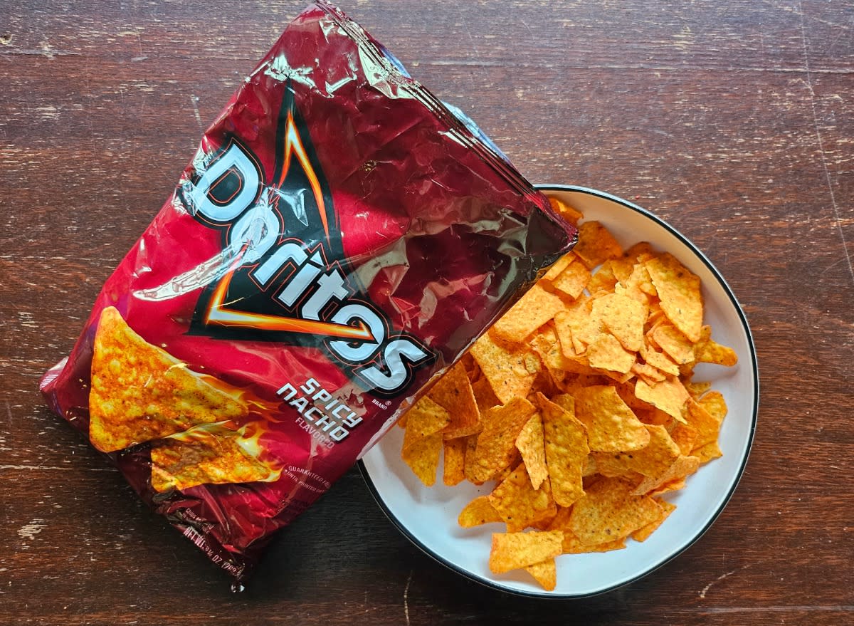 doritos spicy nacho in a bag and a bowl.