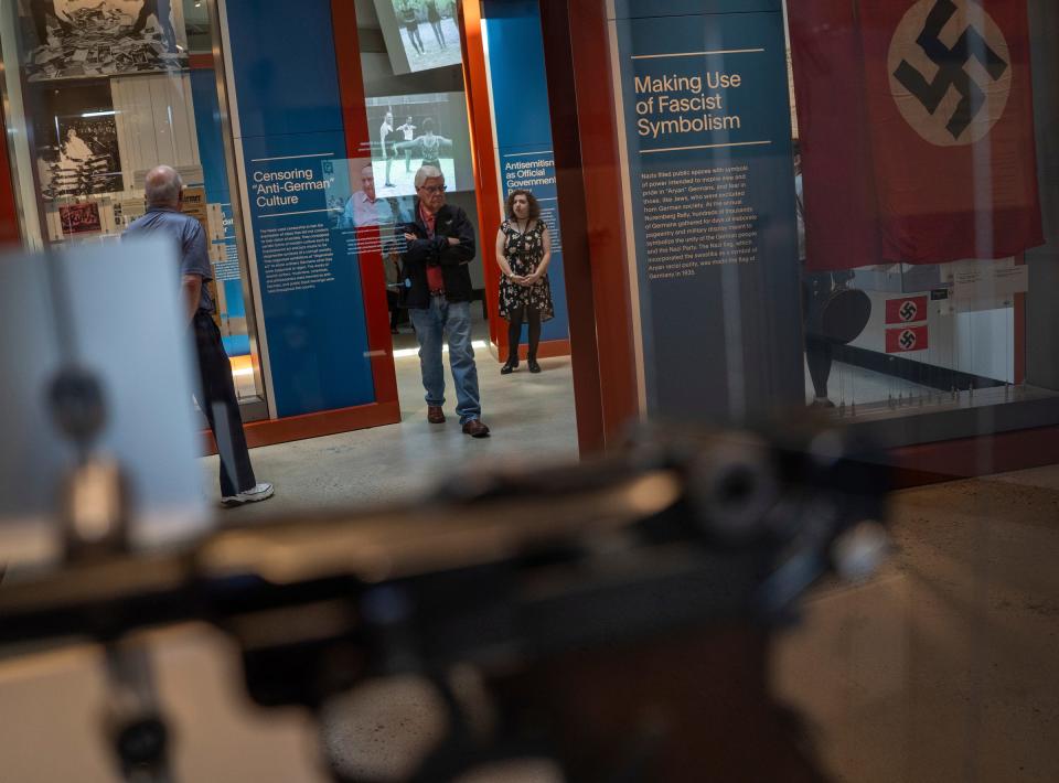 People walk through a section of exhibit showing the rise of Nazis at The Holocaust Center in Farmington Hills on Friday, May 10, 2024.