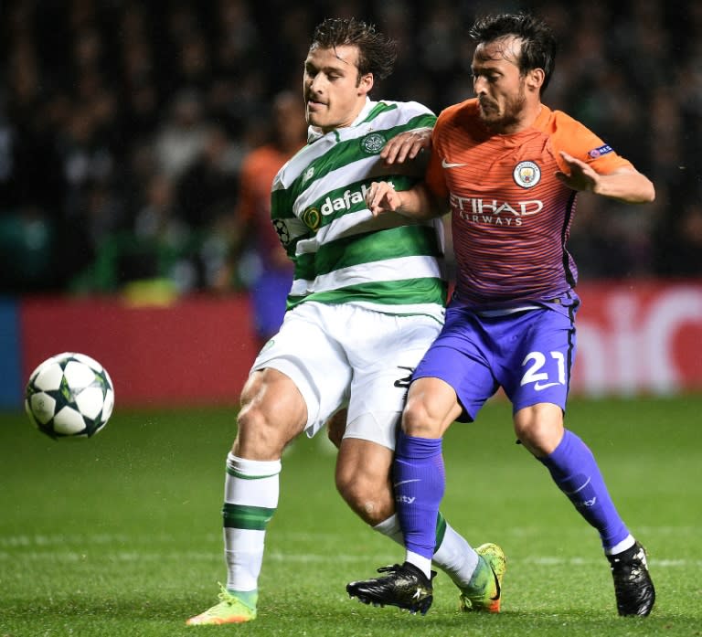 Celtic's Danish defender Erik Sviatchenko (L) vies with Manchester City's Spanish midfielder David Silva during the UEFA Champions League Group C football match between Celtic and Manchester City