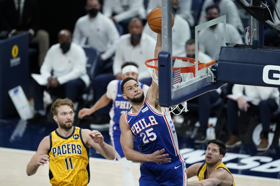 Philadelphia 76ers' Ben Simmons (25) dunks against Indiana Pacers' Domantas Sabonis (11) during the first half of an NBA basketball game, Tuesday, May 11, 2021, in Indianapolis. (AP Photo/Darron Cummings)