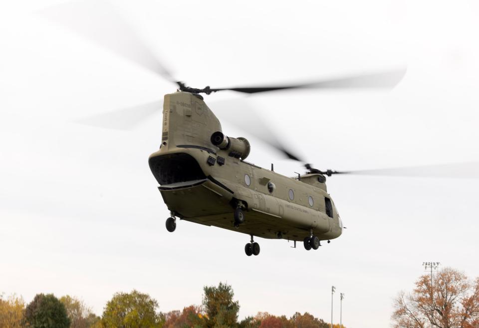 A CH-47 Chinook helicopter takes off from the rear of Perry High School on Thursday with Junior ROTC students from Perry and McKinley high schools. The aircraft was manned with crew from the Ohio National Guard's 3rd Battalion, 238th Aviation Regiment based in North Canton.