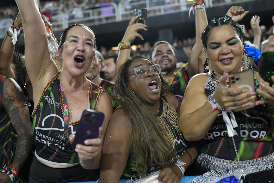 People attend the Beija Flor samba school parade during Carnival celebrations at the Sambadrome in Rio de Janeiro, Brazil, late Sunday, Feb. 11, 2024. (AP Photo/Silvia Izquierdo)