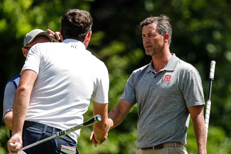 Adam Scott, right, shakes hands with Keegan Bradley after finishing on the 9th green during Round 2 of the Rocket Mortgage Classic at the Detroit Golf Club in Detroit on Friday, July 29, 2022. Scott shot 6-under-par 66 on his round.