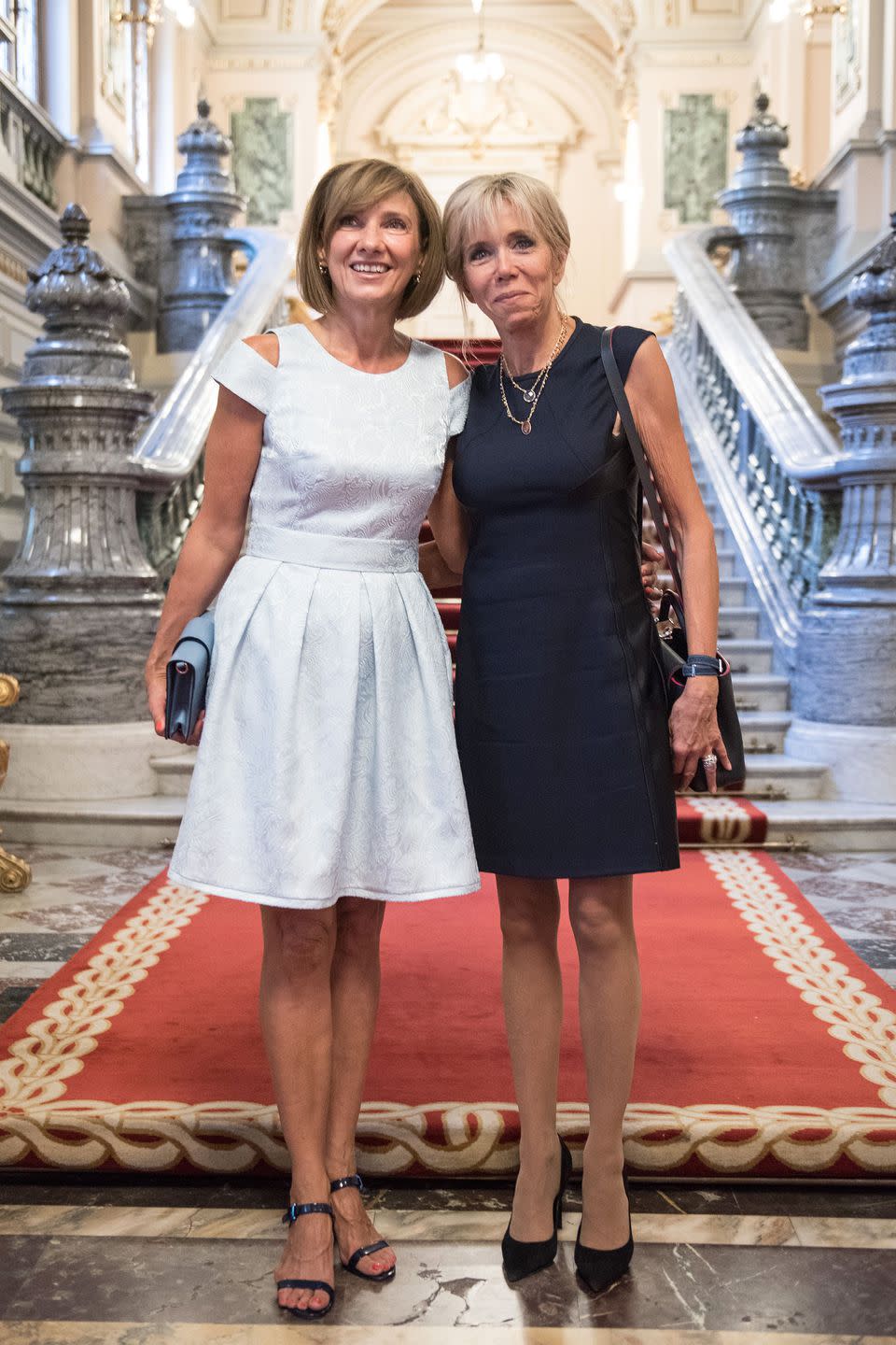 <p>In a navy blue paneled sheath dress with layered gold necklaces, pointed-toe pumps, and a sling bag with the first lady of Romania, Carmen Iohannis, at Cotroceni Palace in Bucharest.</p>