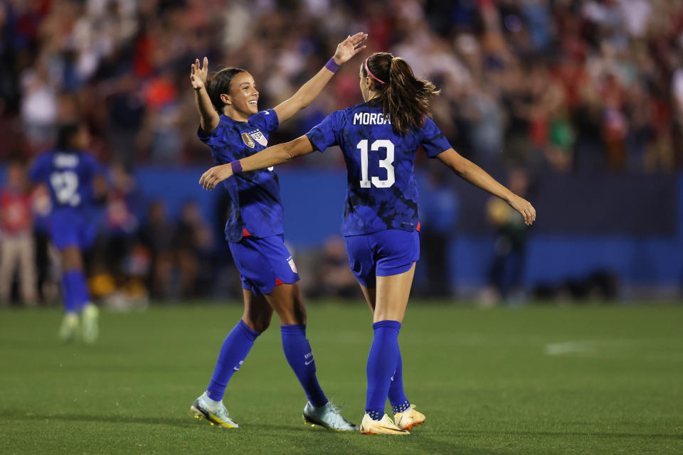 FRISCO, TX - FEBRUARY 22: Alex Morgan #13 of United States celebrates with teammate Mallory Swanson #9 after scoring the team&#39;s first goal during a 2023 SheBelieves Cup match between United States and Brazil at Toyota Stadium on February 22, 2023 in Frisco, Texas. (Photo by Omar Vega/Getty Images)