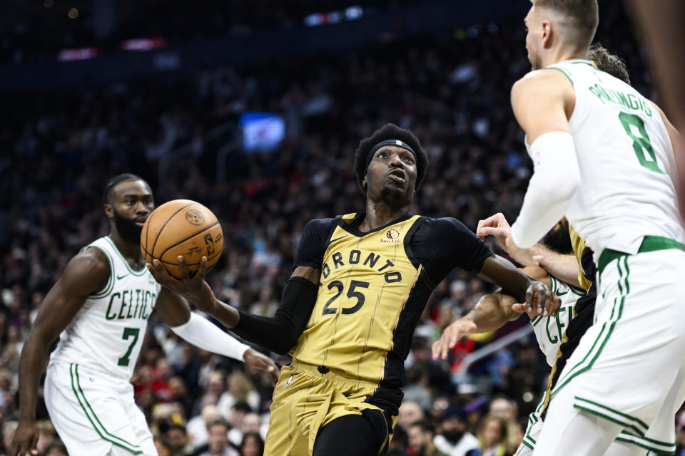 Toronto Raptors forward Chris Boucher (25) goes to the basket during the first half of the team's NBA basketball game against the Boston Celtics on Friday, Nov. 17, 2023, in Toronto. (Christopher Katsarov/The Canadian Press via AP)