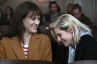 This image released by Hulu shows Mackenzie Davis, left, and Kristen Stewart in a scene from "Happiest Season." (Hulu via AP)