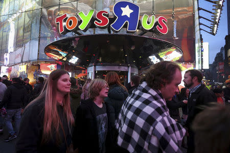 FILE PHOTO: People walk past Toys R Us in Times Square the day after Christmas in the Manhattan borough of New York, U.S., December 26, 2015. REUTERS/Carlo Allegri/File Photo