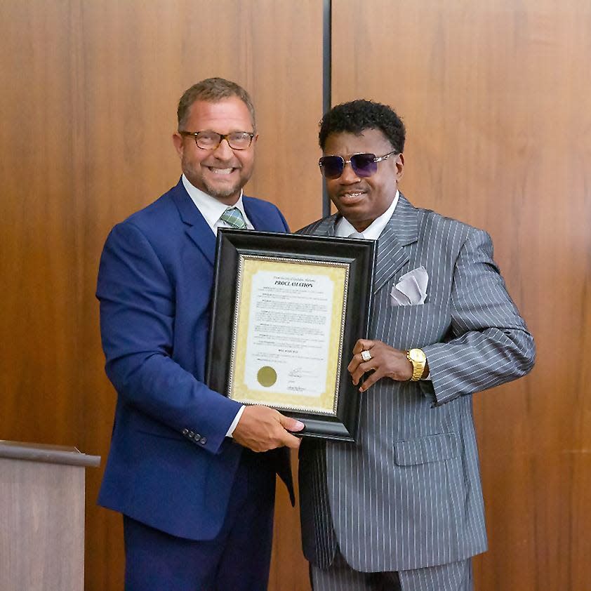 Soul singer Bill Avery receives a proclamation from John Moore, director of economic development and governmental affairs, declaring May 19 as "Bill Avery Day" in Gadsden during a City Council meeting.