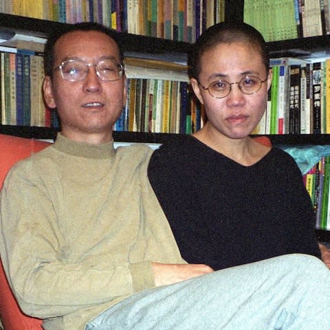This photo taken on 2002 shows Liu Xiaobo (L) and his wife Liu Xia (R) posing for a picture in Beijing - Credit: AFP