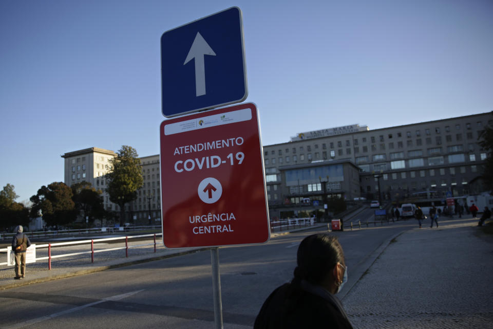 FILE - In this Jan. 18, 2021, file photo, a sign shows the way to the COVID-19 emergency ward at the Santa Maria hospital in Lisbon. In its fight against COVID-19, Portugal lifted restrictions on gatherings and movements for four days over Christmas so that people could spend the festive season with family and friends. Soon after the holiday, the pandemic quickly got out of hand. (AP Photo/Armando Franca)