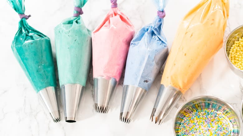colored buttercream in piping bags